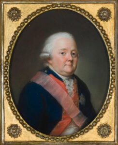 Portrait of Friedrich Riedesel, a round faced man with white hair, rosy cheeks, wearing a dark jacket with red lapels, white shirt underneath with a lace cravat. A military sash sits diagonally across his body over the jacket. 